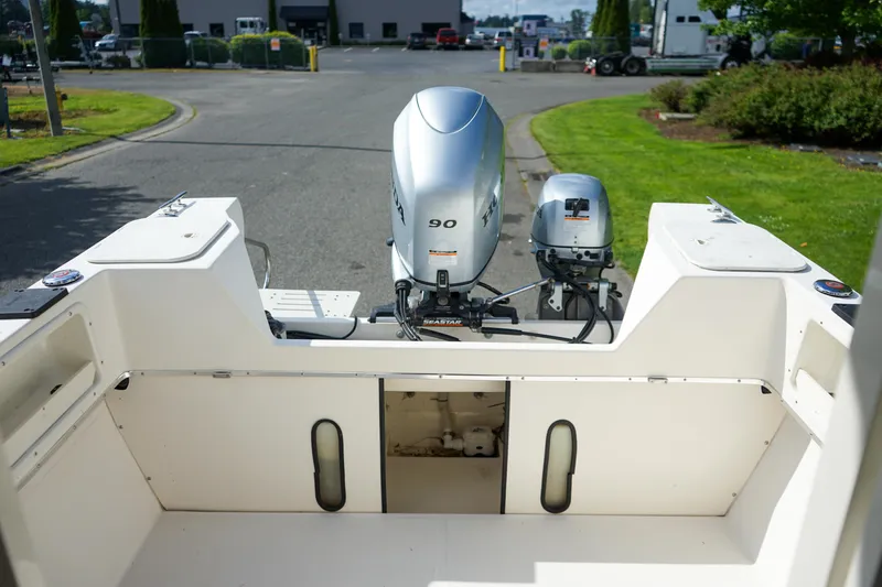 Slide: The Image of 2016 C-Dory 22' Cruiser boat with dual outboard motors, parked in a lot. - 6