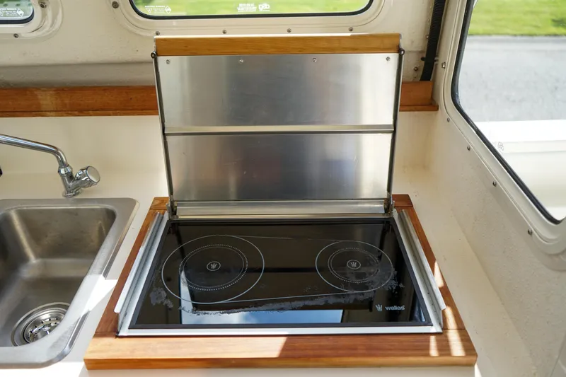 Slide: The Image of C-Dory 22' Cruiser 2016 kitchen with stainless steel stove and sink. - 9