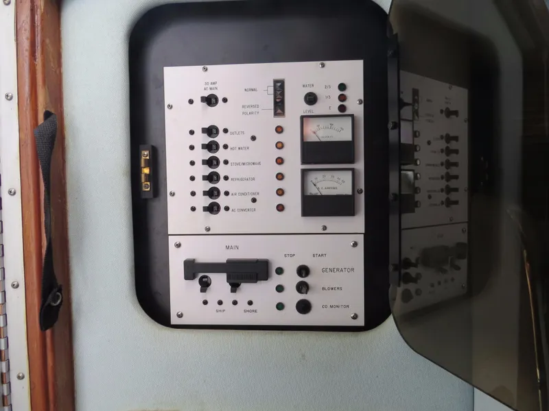 Slide: The Image of Control panel of a 1989 Sea Ray Sundancer 280 boat, featuring various switches and gauges. - 11