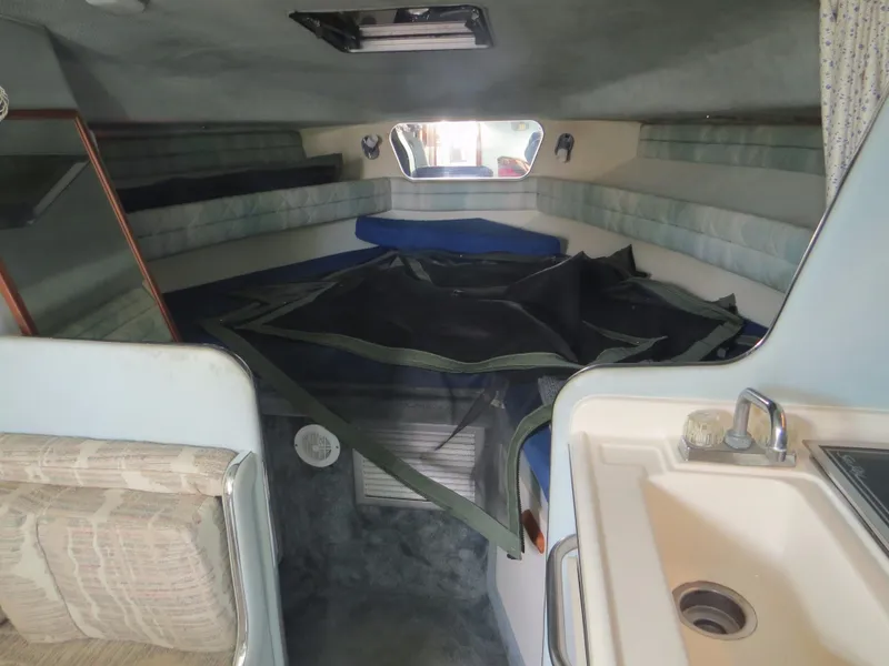 Slide: The Image of 1989 Sea Ray Sundancer 280 cabin interior with seating and sink. - 14