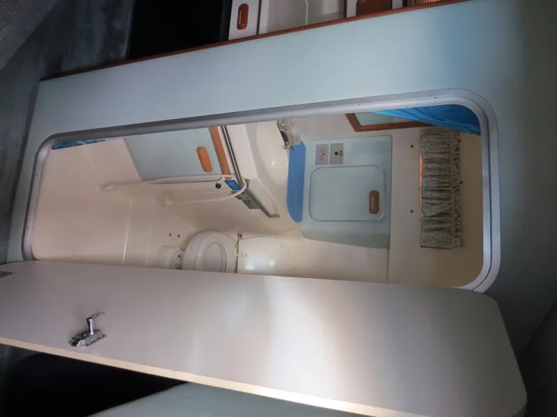 Slide: The Image of Interior view of 1989 Sea Ray Sundancer 280 bathroom with toilet and sink. - 19