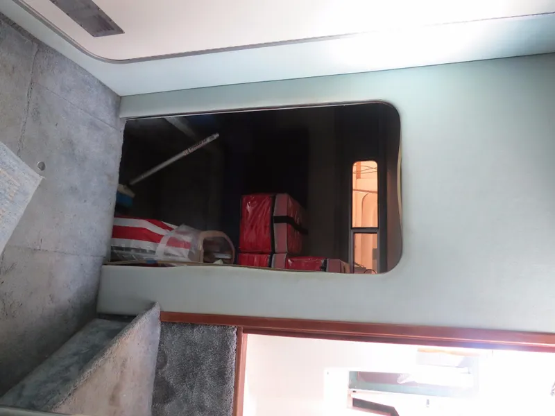 Slide: The Image of Interior view of 1989 Sea Ray Sundancer 280 with storage area and red boxes. - 21