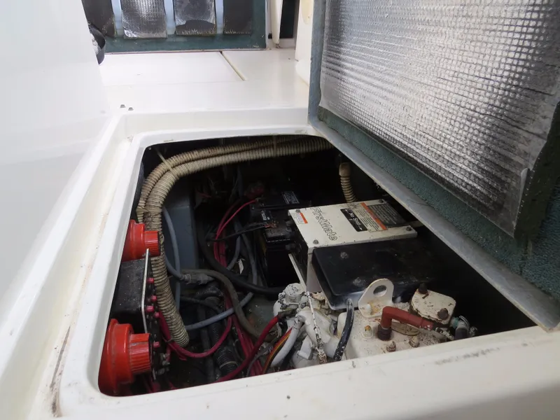 Slide: The Image of Engine compartment of 1989 Sea Ray Sundancer 280 with visible wiring and components. - 22