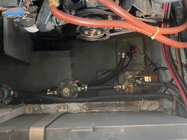 Slide: The Image of Engine compartment of a 1989 Sea Ray Sundancer 280 with visible hoses and components. - 29