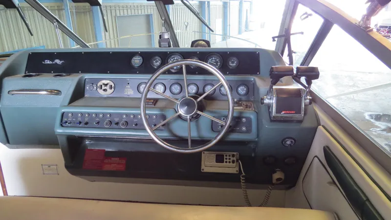 Slide: The Image of 1989 Sea Ray Sundancer 280 helm with steering wheel and control panel. - 7