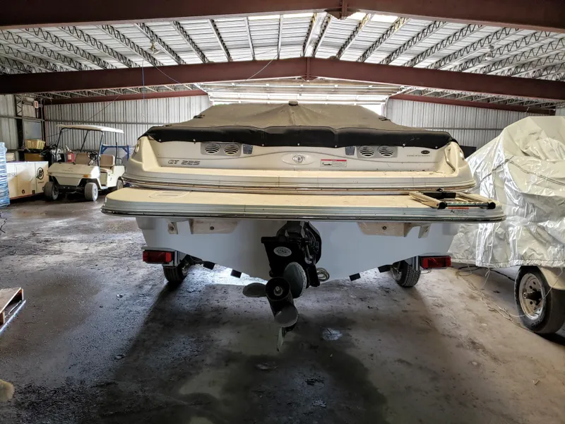 Slide: The Image of 2010 Glastron/Carlson GT225BR boat stored in a covered garage. - 3