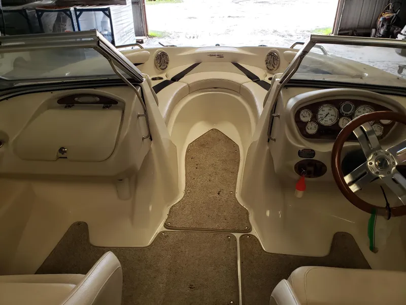 Slide: The Image of 2010 Glastron/Carlson GT225BR boat interior with steering wheel and dashboard controls. - 6