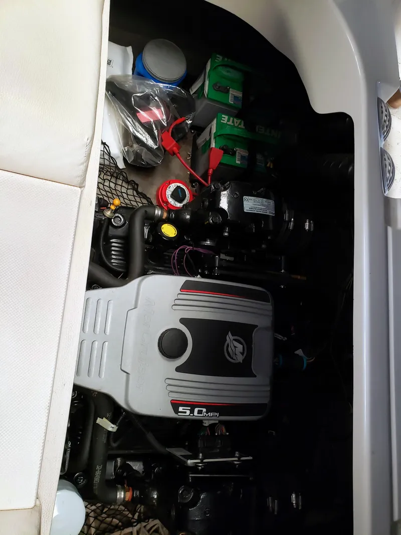 Slide: The Image of Engine compartment of 2010 Glastron/Carlson GT225BR boat with visible components and accessories. - 8