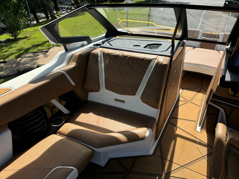 Slide: The Image of 2024 Nautique G25 Paragon interior with luxurious tan seating and modern design. - 10