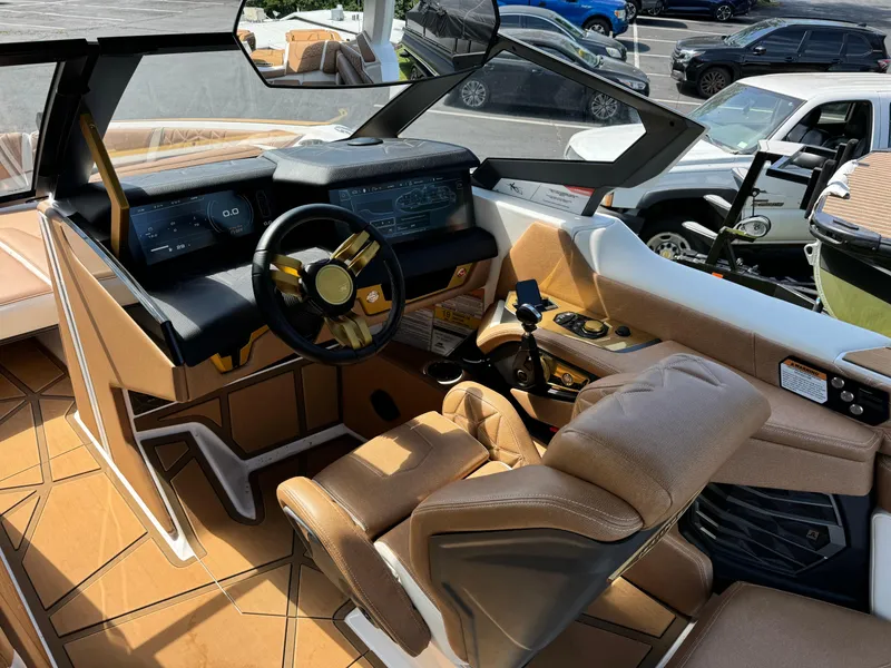 Slide: The Image of 2024 Nautique G25 Paragon boat interior with luxurious seating and advanced dashboard controls. - 11