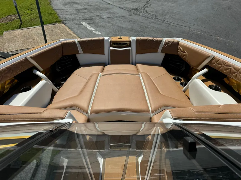 Slide: The Image of 2024 Nautique G25 Paragon boat interior with luxurious tan seating and cup holders. - 12