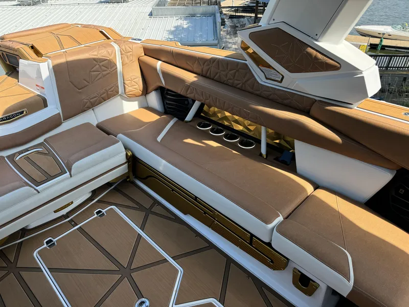 Slide: The Image of 2024 Nautique G25 Paragon interior with luxurious brown and white seating. - 8