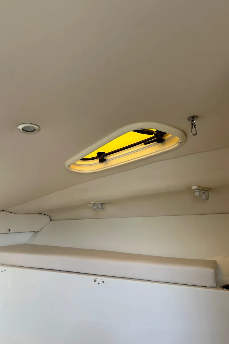 Slide: The Image of Interior view of a 2005 Hydra-Sports 33VX boat cabin with a ceiling hatch. - 10