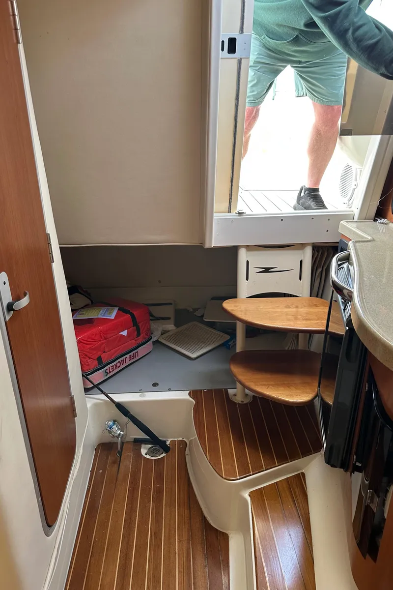 Slide: The Image of Interior view of 2005 Hydra-Sports 33VX boat with wooden steps and storage area. - 12