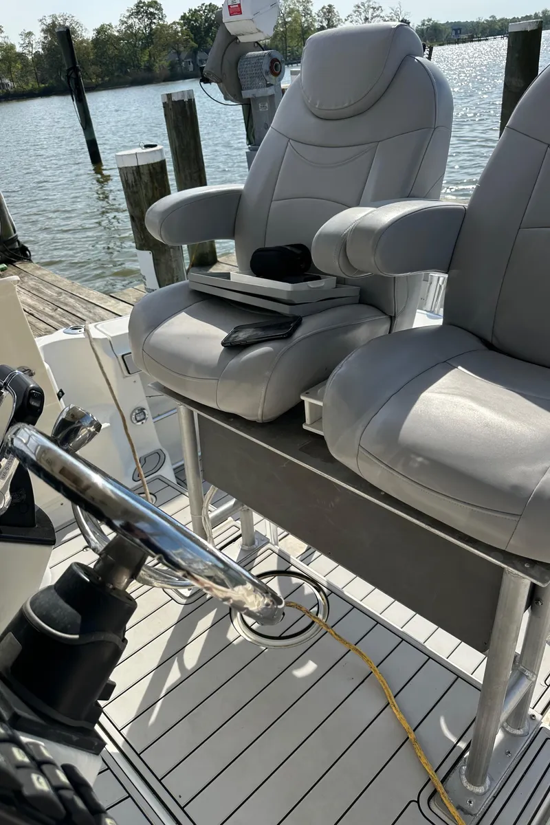 Slide: The Image of 2005 Hydra-Sports 33VX boat cockpit with dual captain chairs and steering wheel. - 3