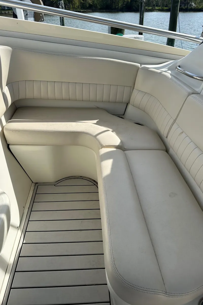 Slide: The Image of 2005 Hydra-Sports 33VX boat interior with white cushioned seating and wooden flooring. - 4
