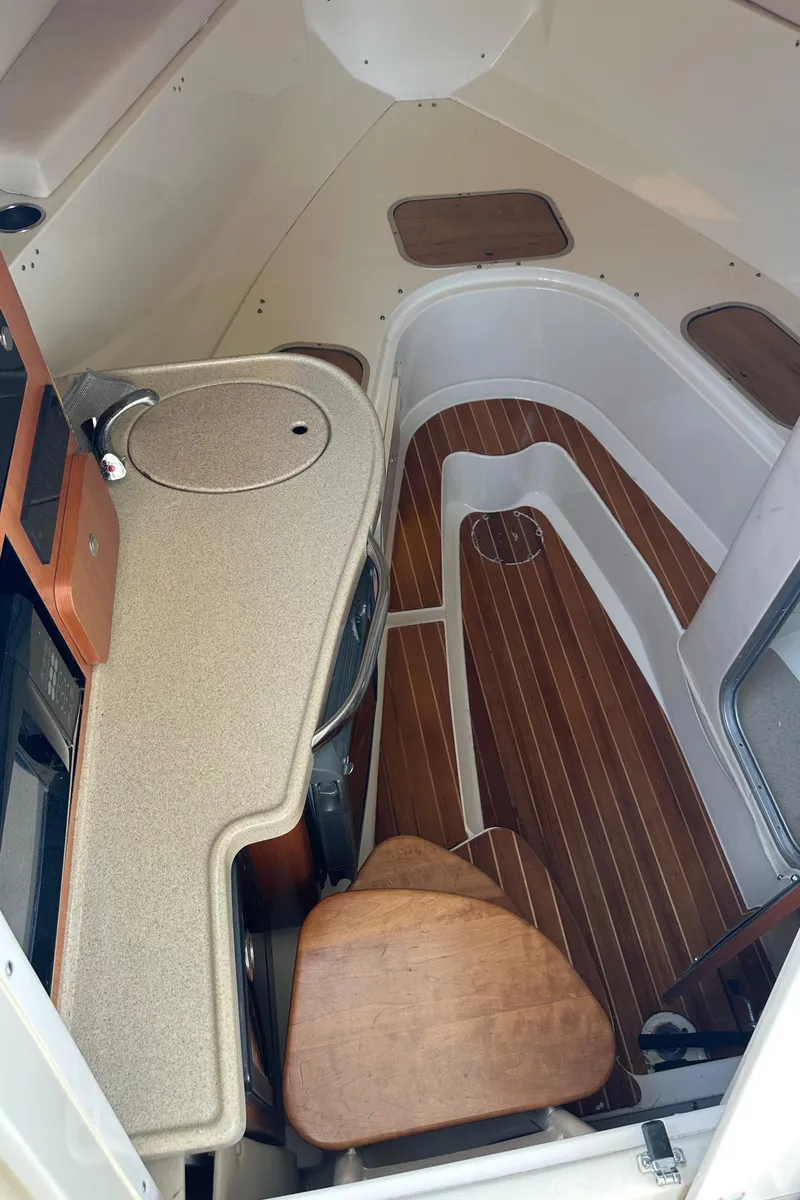 Slide: The Image of 2005 Hydra-Sports 33VX cabin interior with wood flooring and compact kitchenette. - 5
