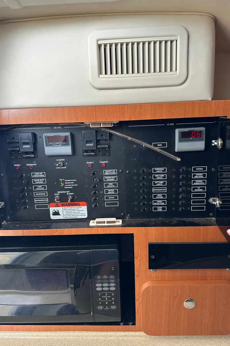 Slide: The Image of Control panel and microwave inside a 2005 Hydra-Sports 33VX boat cabin. - 6
