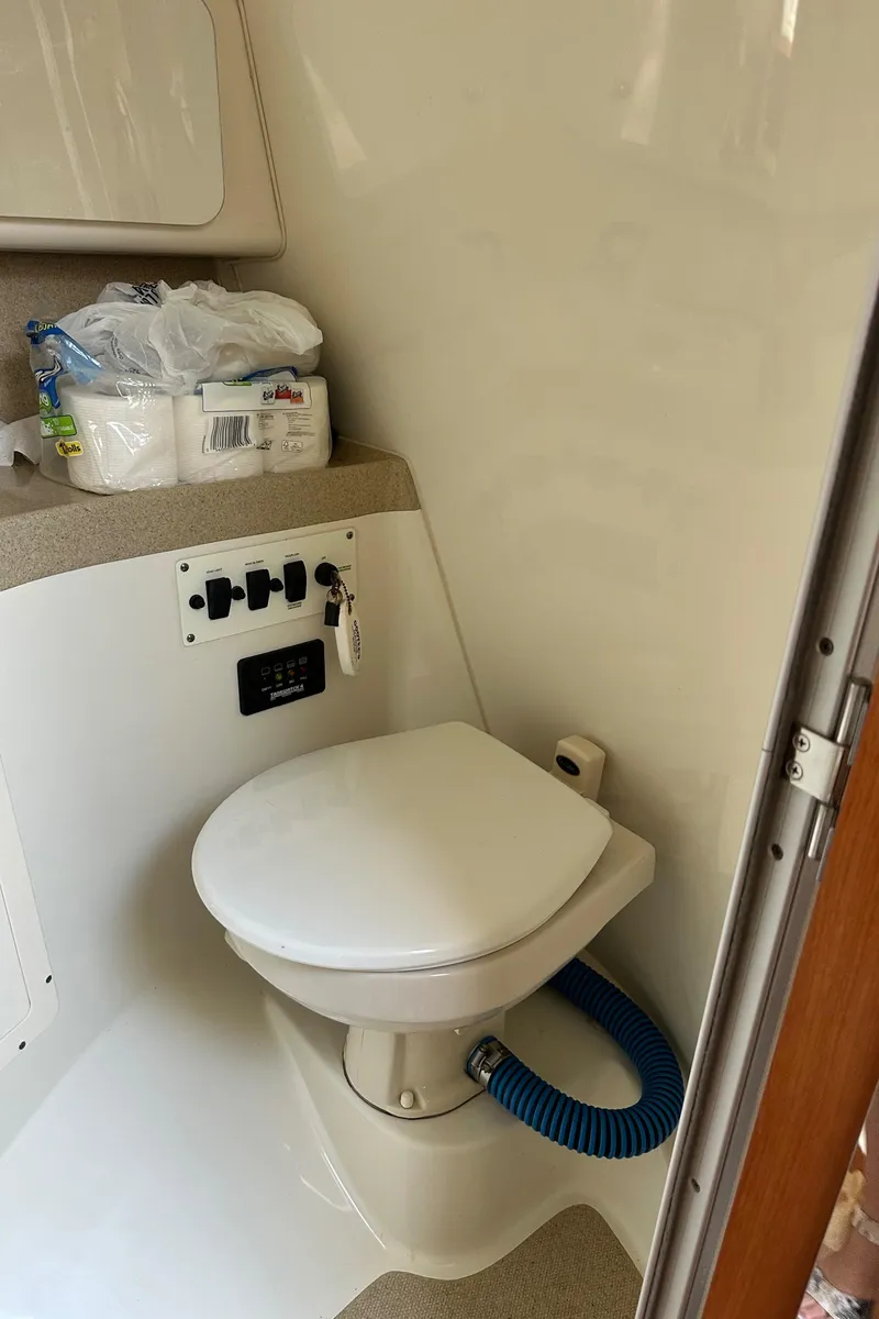 Slide: The Image of 2005 Hydra-Sports 33VX boat bathroom with toilet and storage shelf. - 7