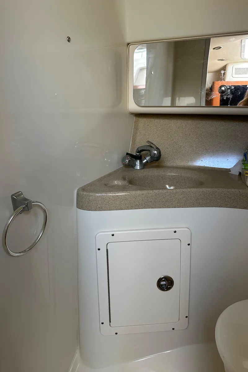 Slide: The Image of 2005 Hydra-Sports 33VX boat bathroom with sink, mirror, and storage compartment. - 8