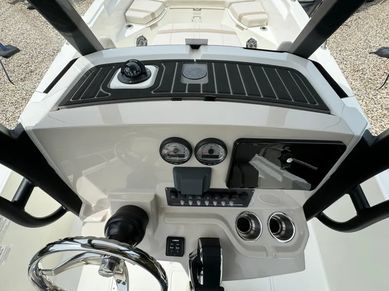 Slide: The Image of 2025 Boston Whaler 250 Dauntless helm with steering wheel, gauges, and controls. - 12