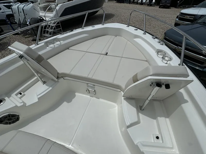 Slide: The Image of 2025 Boston Whaler 250 Dauntless boat interior with cushioned seating and cup holders. - 13