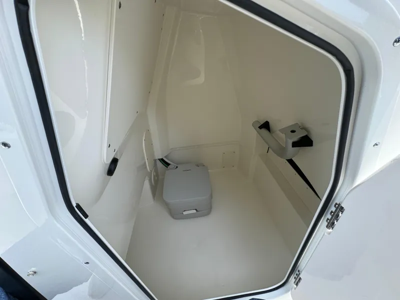 Slide: The Image of Interior of 2025 Boston Whaler 250 Dauntless boat, featuring a compact storage compartment. - 16