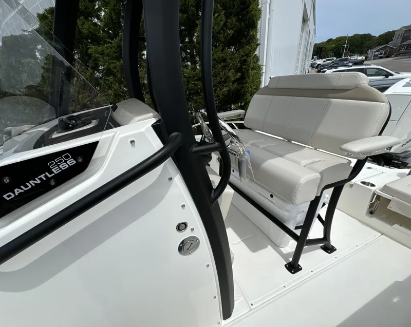 Slide: The Image of 2025 Boston Whaler 250 Dauntless boat interior with seating and console details. - 17