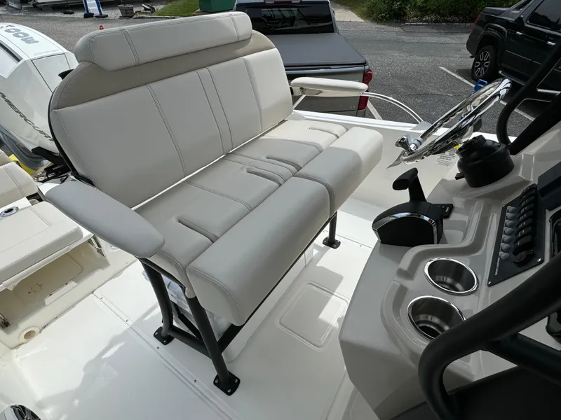 Slide: The Image of 2025 Boston Whaler 250 Dauntless boat interior with beige seating and steering console. - 18