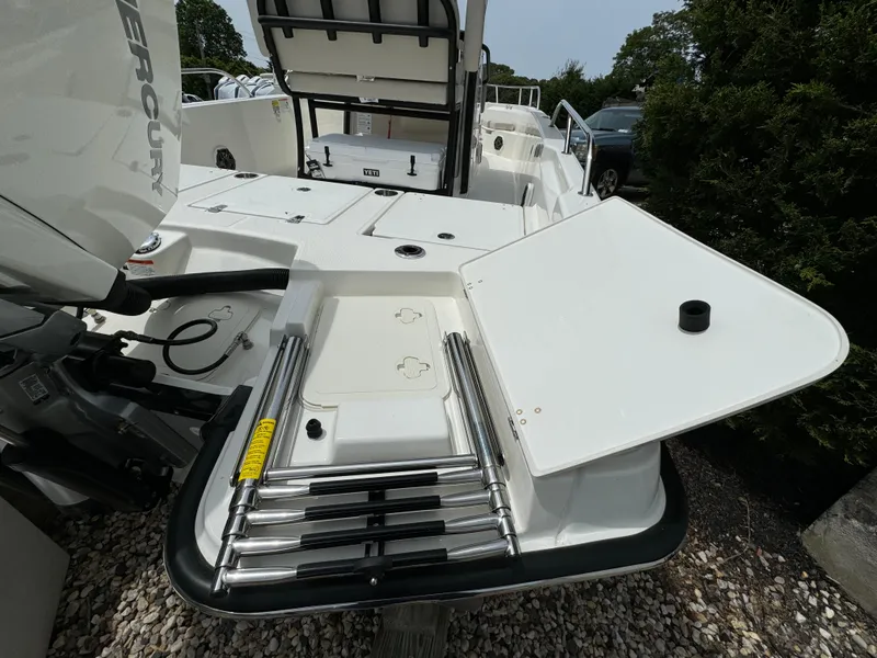 Slide: The Image of 2025 Boston Whaler 250 Dauntless boat with Mercury engine and foldable ladder on deck. - 21