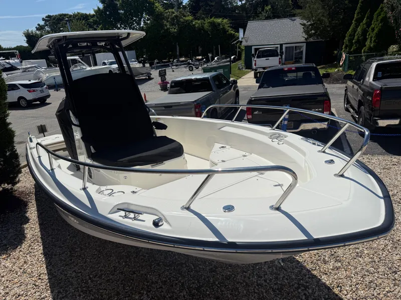 Slide: The Image of 2025 Boston Whaler 250 Dauntless boat displayed outdoors, surrounded by parked vehicles. - 3