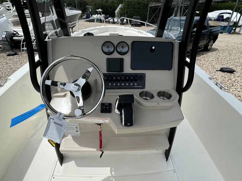 Slide: The Image of 2025 Boston Whaler 250 Dauntless boat console with steering wheel and controls. - 4