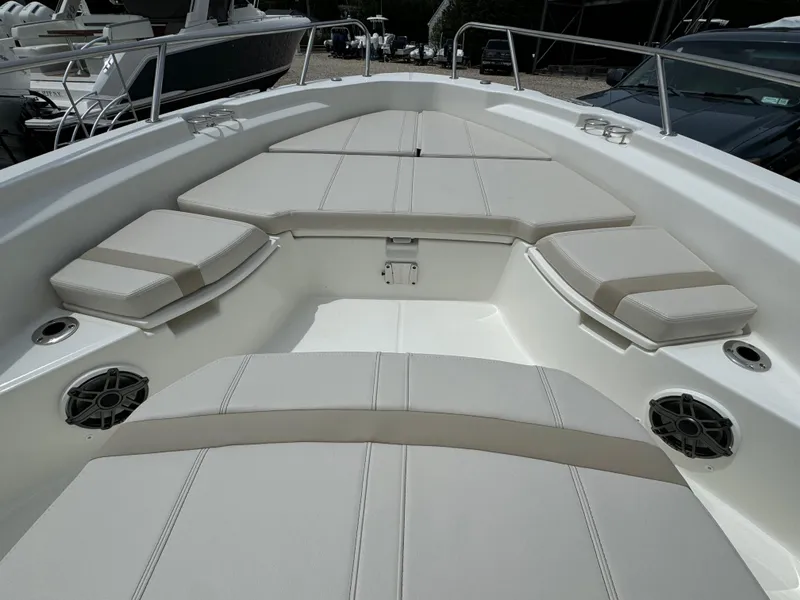 Slide: The Image of 2025 Boston Whaler 250 Dauntless boat interior with cushioned seating and speakers. - 5
