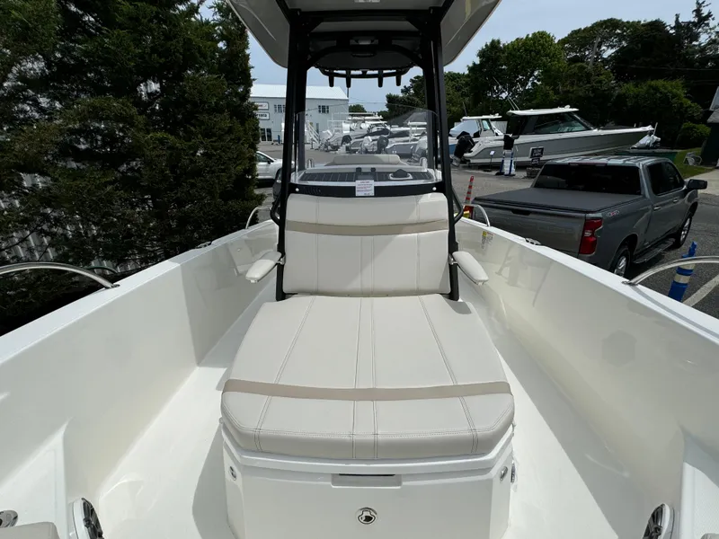 Slide: The Image of 2025 Boston Whaler 250 Dauntless boat interior with cushioned seating and sleek design. - 7