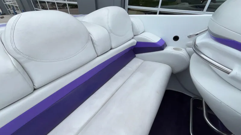 Slide: The Image of 2003 Baja 33 Outlaw boat interior with white and purple seating. - 10
