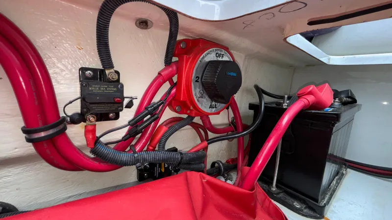 Slide: The Image of Electrical system of a 2003 Baja 33 Outlaw boat with red wiring and battery switch. - 14