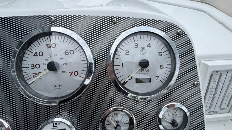 Slide: The Image of Dashboard of a 2003 Baja 33 Outlaw boat with speedometer and tachometer. - 19