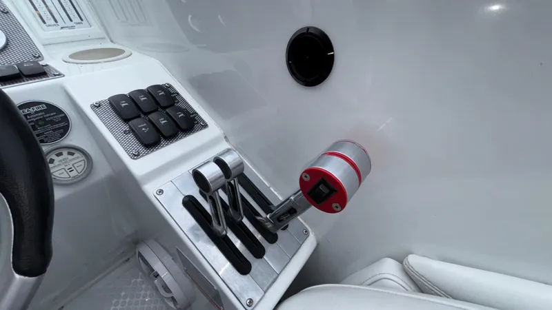 Slide: The Image of 2003 Baja 33 Outlaw boat controls with throttle and switches in cockpit. - 20