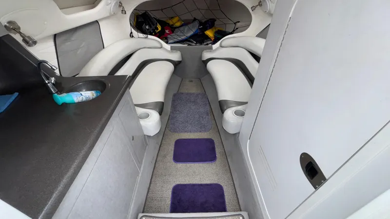 Slide: The Image of 2003 Baja 33 Outlaw cabin interior with seating, sink, and storage. - 23