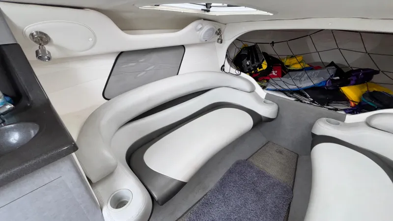 Slide: The Image of 2003 Baja 33 Outlaw cabin interior with white seating and storage area. - 25