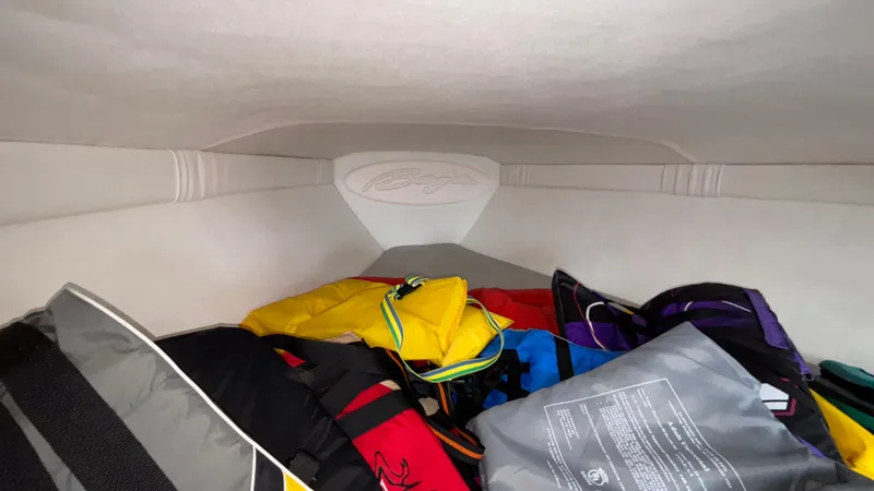 Slide: The Image of Interior storage of 2003 Baja 33 Outlaw boat with colorful life jackets. - 26