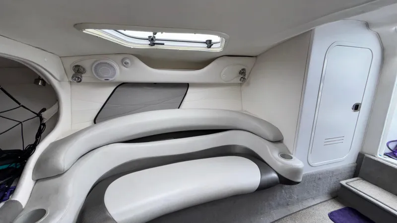 Slide: The Image of 2003 Baja 33 Outlaw cabin interior with curved seating and storage compartments. - 27