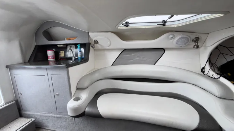 Slide: The Image of 2003 Baja 33 Outlaw cabin interior with seating, storage, and a small counter. - 28