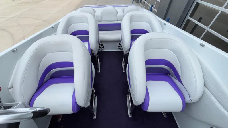 Slide: The Image of 2003 Baja 33 Outlaw boat interior with white and purple seating. - 32