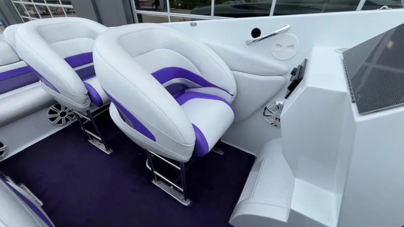 Slide: The Image of 2003 Baja 33 Outlaw boat interior with white and purple seating. - 33