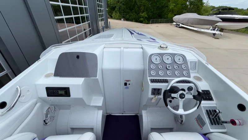 Slide: The Image of 2003 Baja 33 Outlaw boat cockpit with steering wheel and instrument panel. - 37