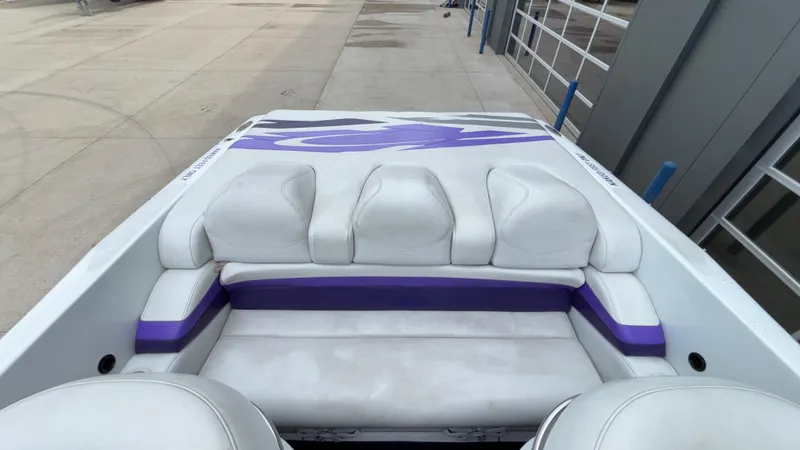 Slide: The Image of 2003 Baja 33 Outlaw boat interior with white and purple seating. - 8