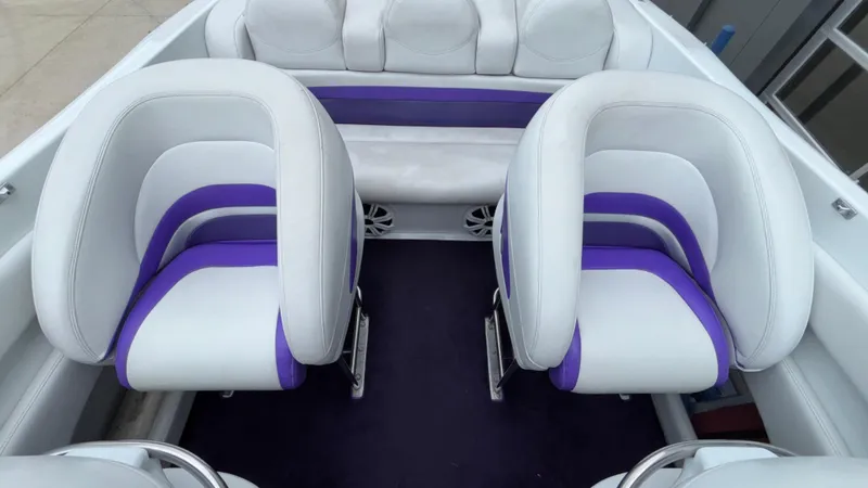 Slide: The Image of 2003 Baja 33 Outlaw boat interior with white and purple seating. - 9