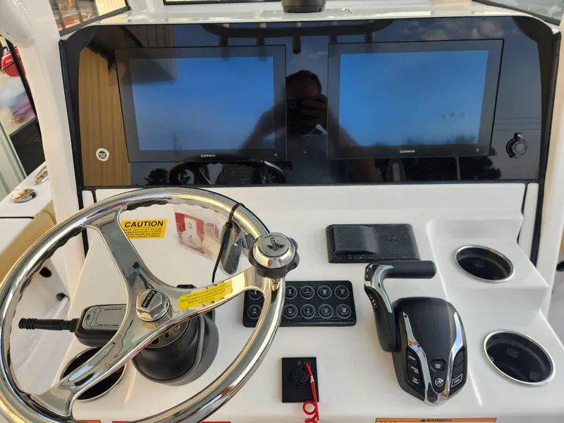 Slide: The Image of 2025 Sportsman Masters 247OE Bay Boat dashboard with dual Garmin displays and steering wheel. - 15