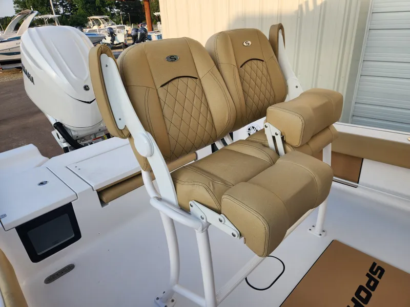 Slide: The Image of 2025 Sportsman Masters 247OE Bay Boat with tan cushioned seating and white frame. - 17